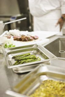 Chef preparing food in commercial kitchen. Date : 2008