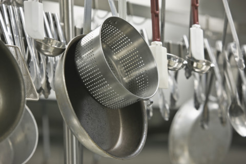 Pots and cooking utensils hanging from rack. Date : 2008