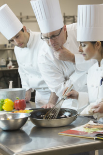 Head chef inspecting cooking techniques. Date : 2008
