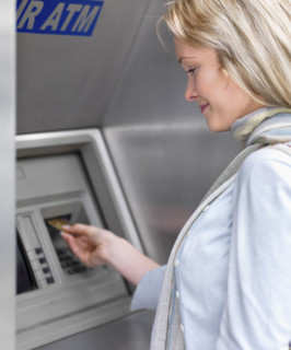 Woman using cash machine. Date : 2008