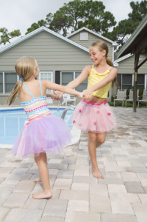 Girls in tutus playing by swimming pool. Date : 2008
