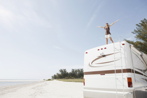 Young woman standing on top of motor home. Date : 2008