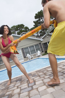Couple playing tug-of-war with towel. Date : 2008