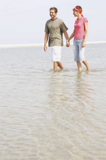 Couple wading in ocean. Date : 2008