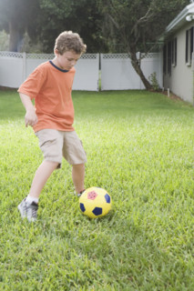 Boy playing in soccer in backyard. Date : 2008