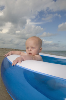 Baby boy sitting in inflatable swimming pool. Date : 2008