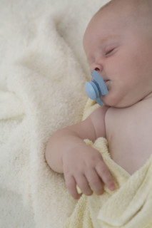 Baby sleeping with pacifier in mouth. Date : 2008