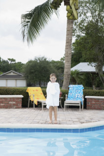 Girl standing at edge of swimming pool. Date : 2008