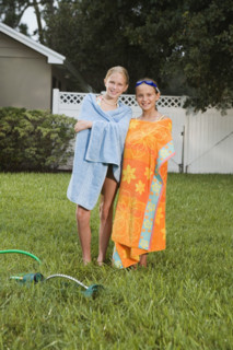 Girls wrapped in towels on lawn. Date : 2008