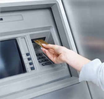 Woman using cash machine. Date : 2008