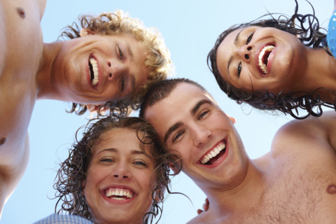 Low angle view of young friends in huddle. Date : 2008