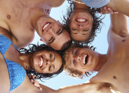 Low angle view of young friends in huddle. Date : 2008