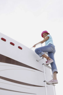 Girl climbing on motor home ladder. Date : 2008