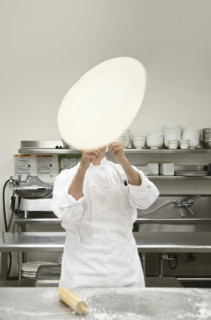 Chef tossing pizza dough. Date : 2008