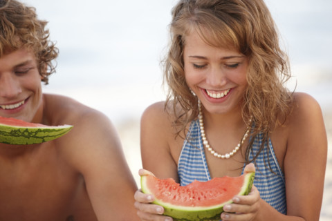 Young couple eating watermelon on beach. Date : 2008