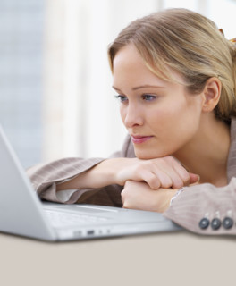 Businesswoman looking at laptop. Date : 2008