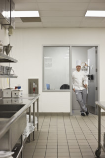 Chef standing in doorway of kitchen office. Date : 2008