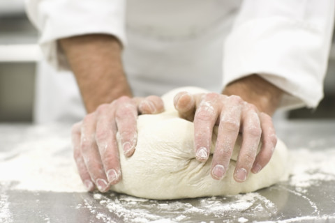Baker kneading bread dough. Date : 2008