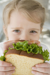 Girl eating sandwich. Date : 2008