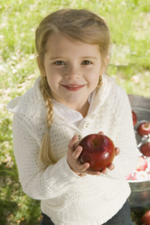 Girl bobbing for apples. Date : 2008