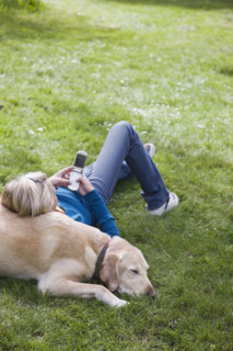 Girl leaning on dog in park. Date : 2008