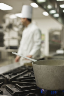 Chef and pot on stove. Date : 2008