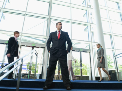 Confident businessman posing in lobby. Date : 2008