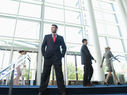 Confident businessman posing in lobby. Date : 2008