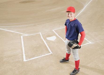 Baseball player in uniform posing by home plate. Date : 2008