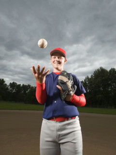 Baseball pitcher tossing ball in air. Date : 2008