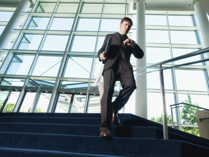 Businessman descending office building stairs. Date : 2008