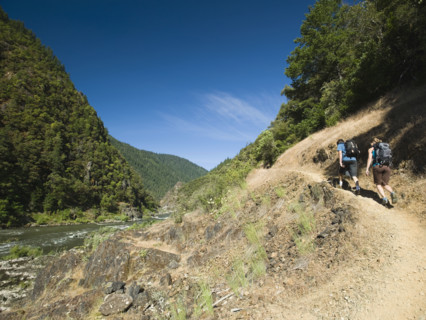 Hikers walking on riverside trail. Date : 2008