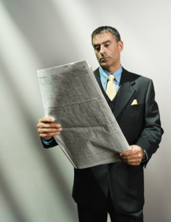 Businessman reading newspaper. Date : 2008