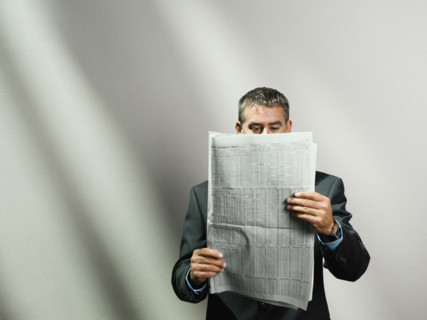 Businessman reading newspaper. Date : 2008