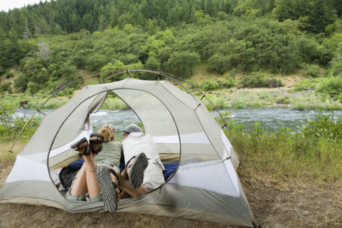 Couple relaxing in tent. Date : 2008