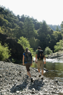 Hikers walking along river. Date : 2008