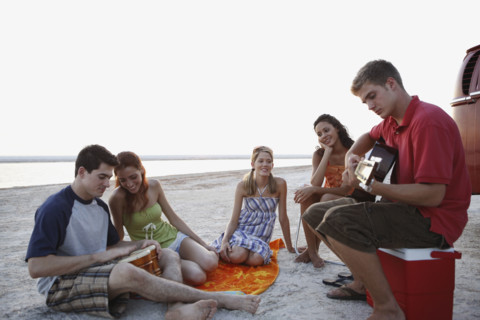Friends socializing on beach. Date : 2008
