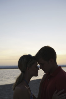 Young couple hugging on beach at sunset. Date : 2008