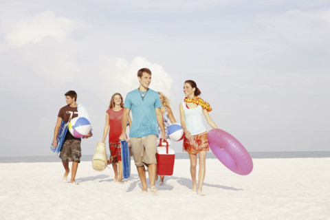 Friends walking with beach essentials. Date : 2008