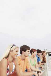 Friends posing on boardwalk railing. Date : 2008