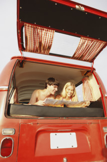 Teenage couple relaxing in van on beach. Date : 2008