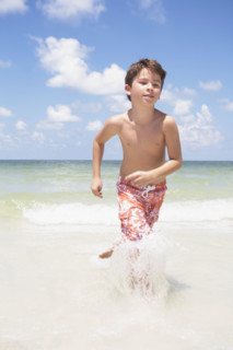 Boy running in ocean. Date : 2008