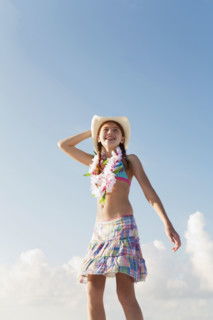 Girl in bathing suit with lei around neck. Date : 2008