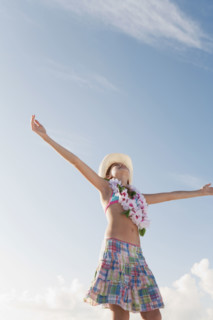 Girl in bathing suit with lei around neck. Date : 2008