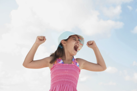 Girl at beach making funny face. Date : 2008