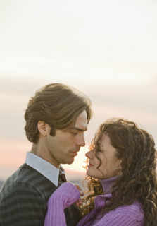 Couple face to face with eyes closed.