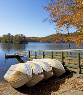 Row boats tied to dock. Date: 2008