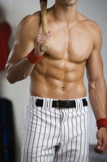 Portrait of baseball player with bare chest holding bat. Date : 2008