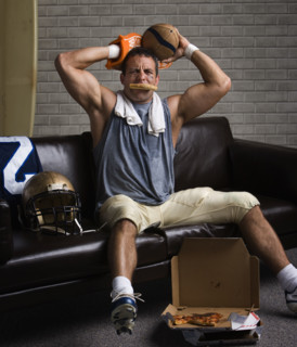 Football player with pizza in mouth looking frustrated. Date: 2008