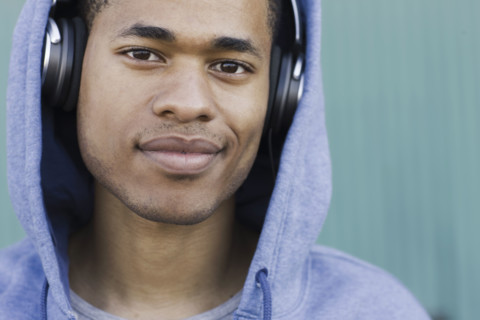 Close up portrait of young man listening to headphones. Date : 2008